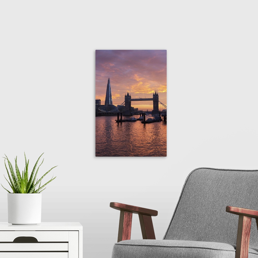 A modern room featuring The Shard and Tower Bridge on the River Thames at sunset, London, England, United Kingdom, Europe.