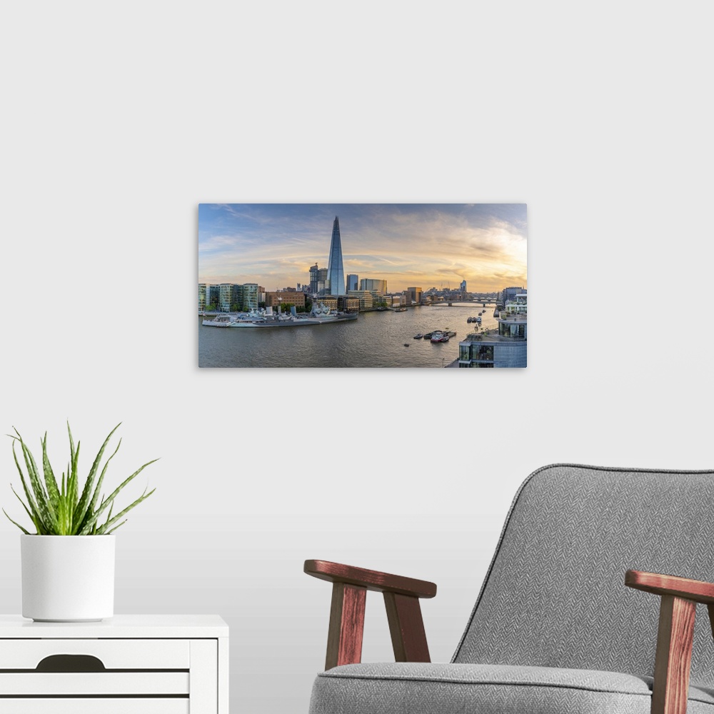 A modern room featuring View of The Shard, HMS Belfast and River Thames from Cheval Three Quays at sunset, London, Englan...