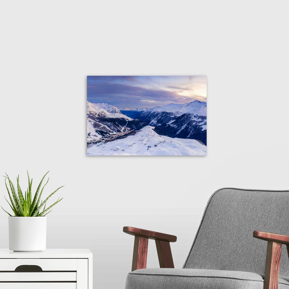 A modern room featuring Aerial view by drone of sunset on the snowy peaks surrounding Madesimo and Andossi, Valchiavenna,...