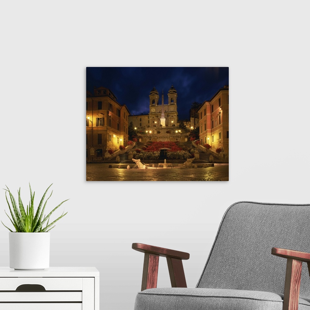 A modern room featuring The Spanish Steps illuminated at night in the city of Rome, Lazio, Italy