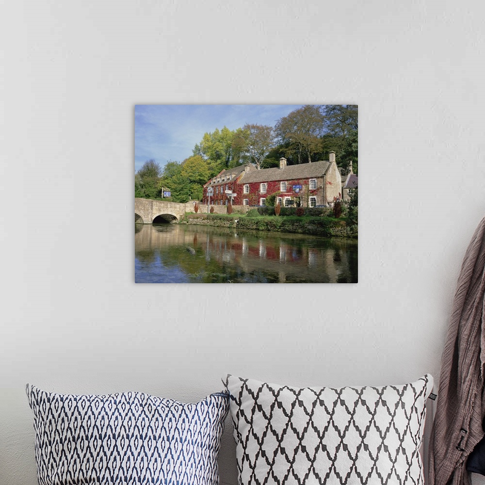 A bohemian room featuring The Swan Hotel reflected in the river at Bibury, Gloucestershire, England