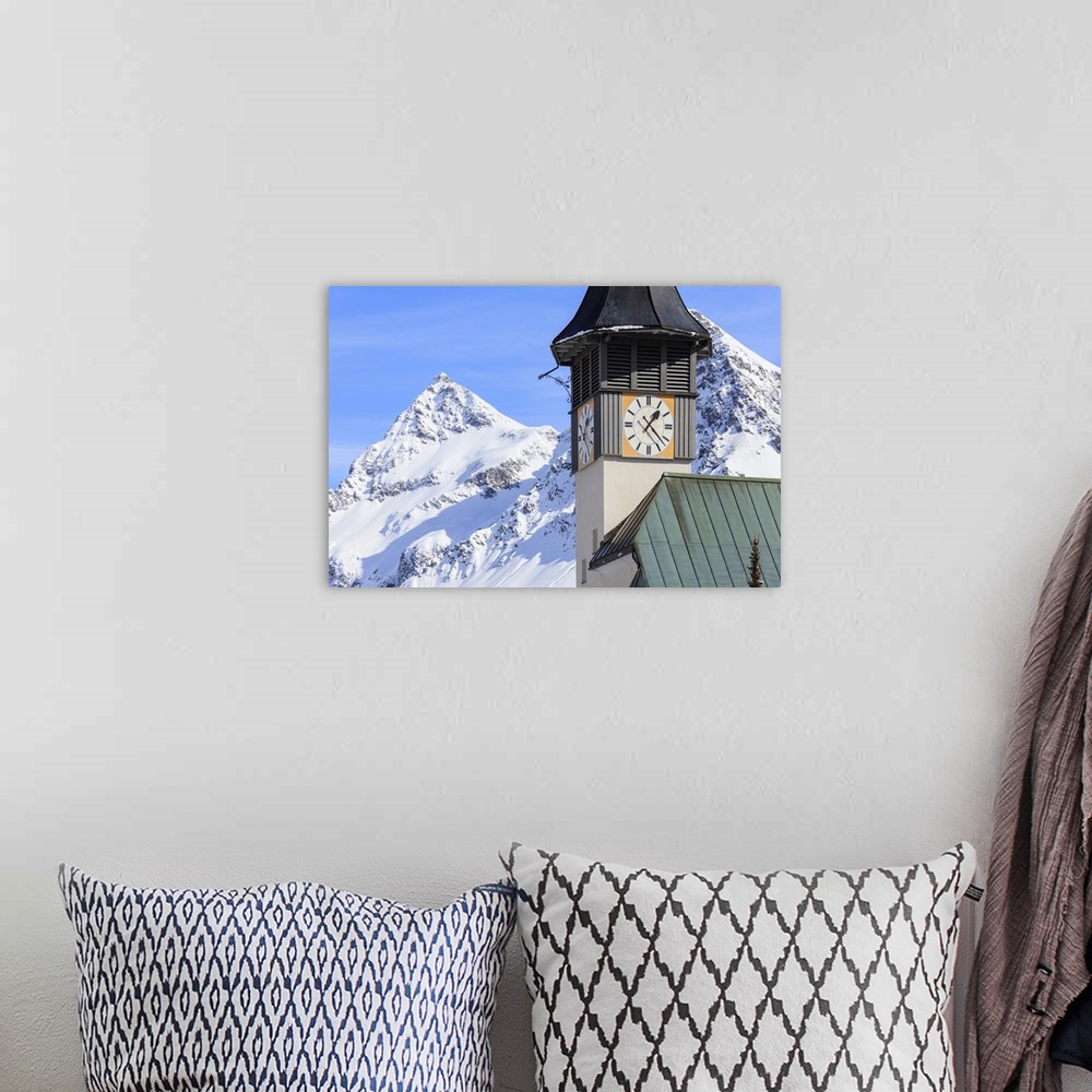 A bohemian room featuring The typical alpine bell tower frames the snowy peaks, Langwies, district of Plessur, Canton of Gr...