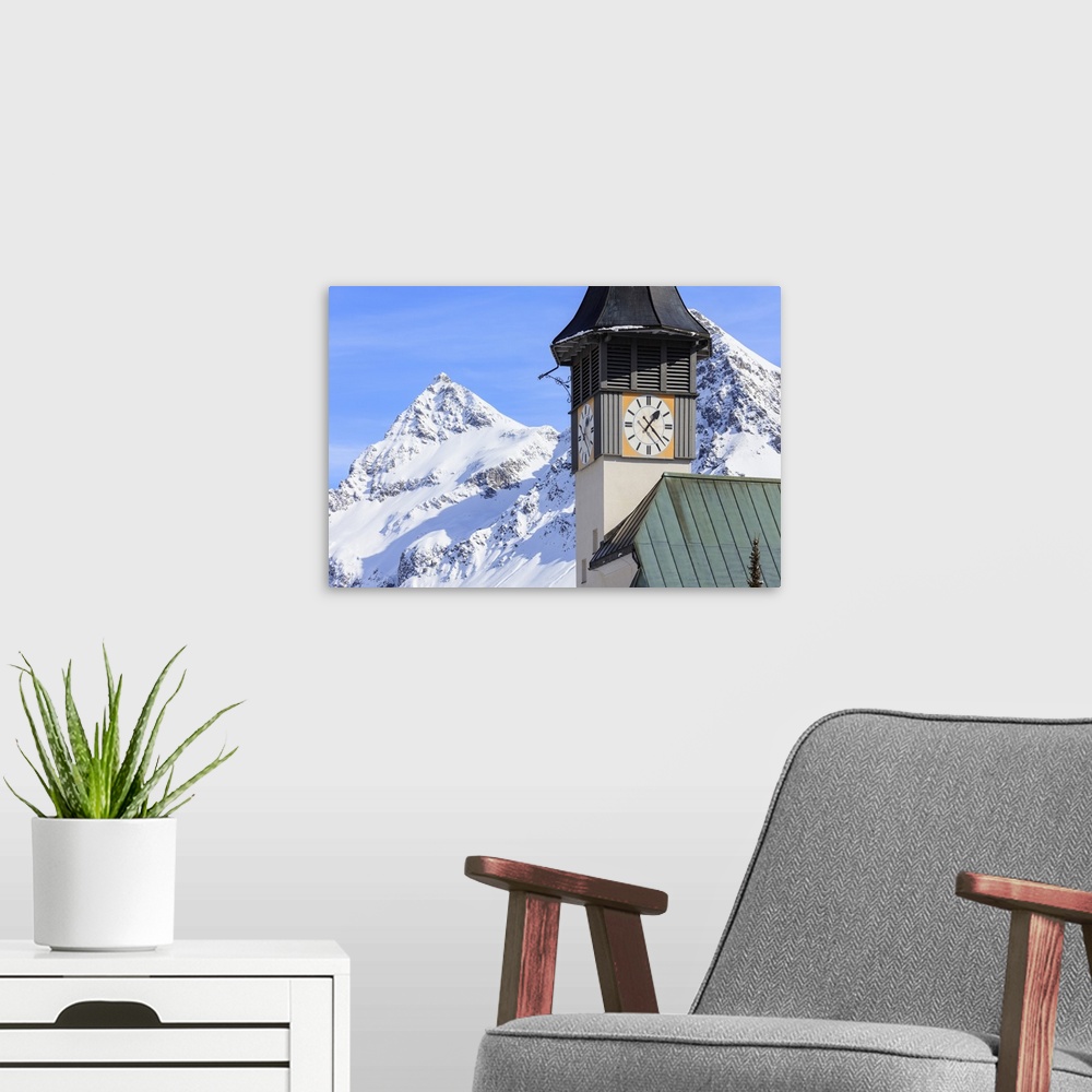 A modern room featuring The typical alpine bell tower frames the snowy peaks, Langwies, district of Plessur, Canton of Gr...