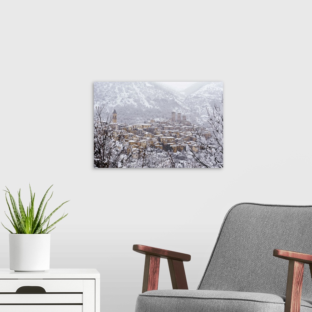 A modern room featuring View of the village and the castle of Pacentro under heavy snowfall, Maiella National Park, L'Aqu...