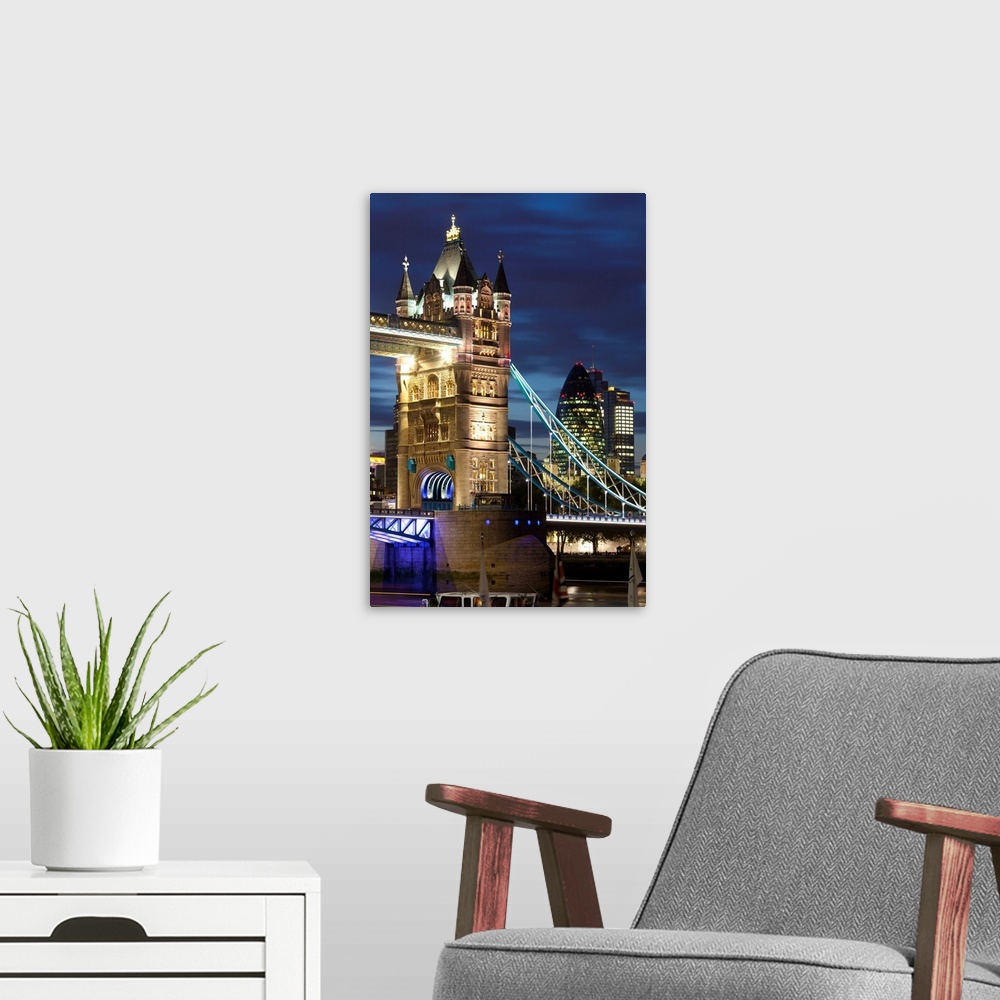 A modern room featuring Tower Bridge and the Financial District at night, London, England, UK, Europe