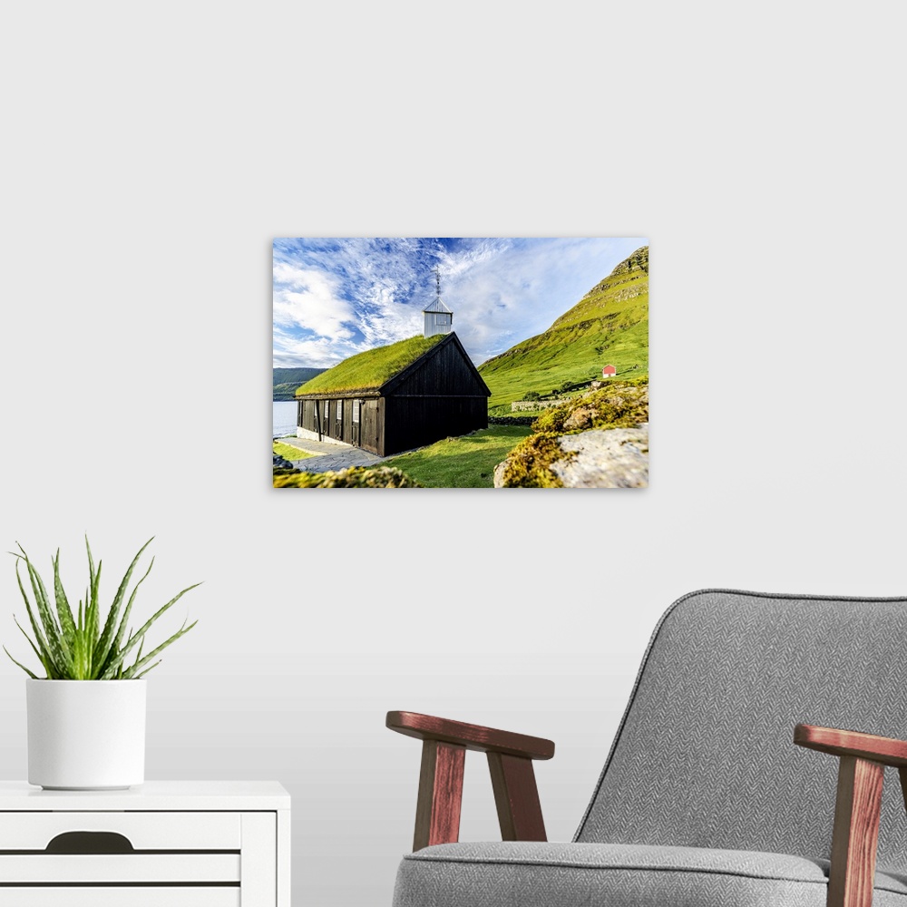 A modern room featuring Traditional church with grass roof overlooking the fjord, Funningur, Eysturoy Island, Faroe Islan...