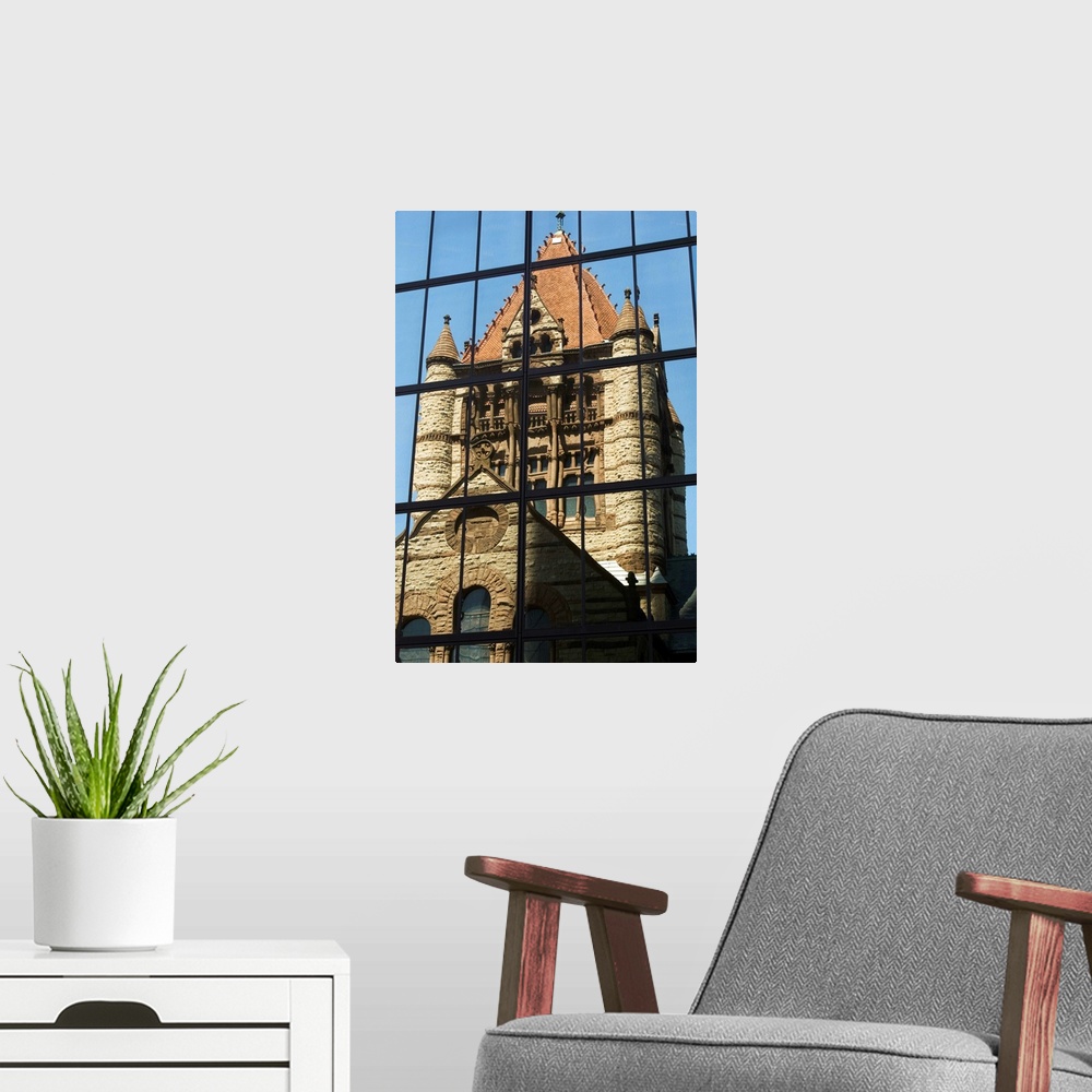 A modern room featuring Trinity Church reflected in the John Hancock Tower, Copley Square, Boston, MA, USA