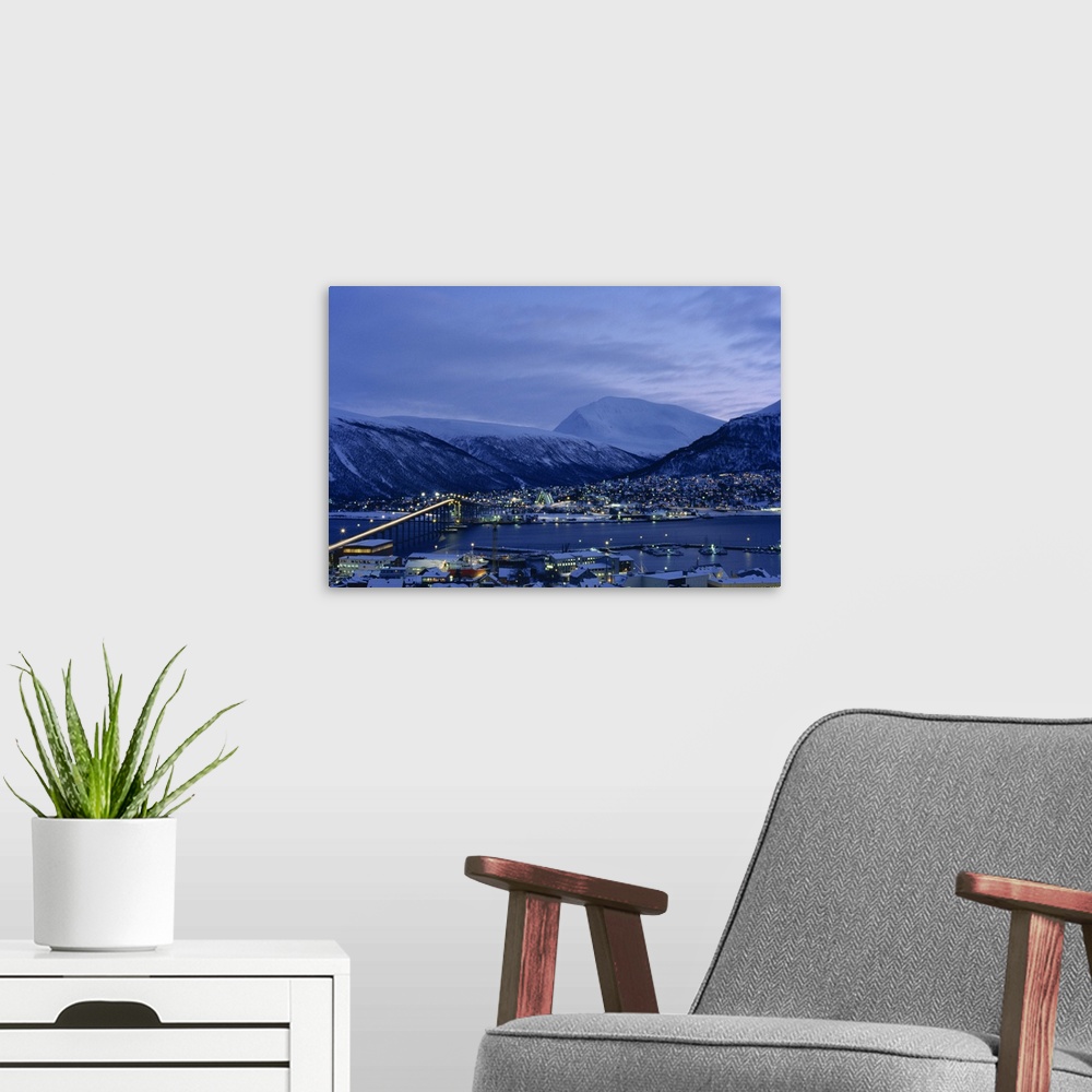 A modern room featuring Tromso and its bridge to the mainland at dusk, Arctic Norway, Scandinavia