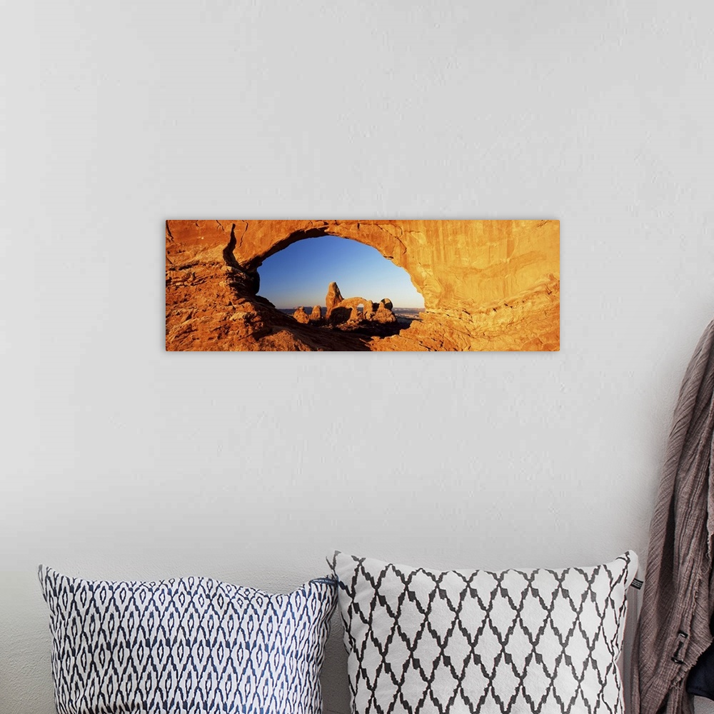 A bohemian room featuring Turret Arch through North Window at sunrise, Arches National Park, Moab, Utah