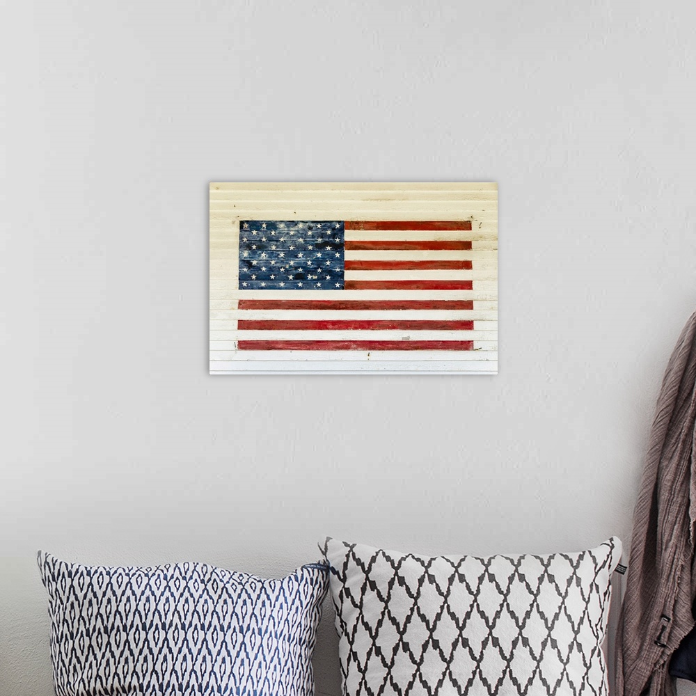 A bohemian room featuring US Flag painted on the side of a wooden building in the historic area of Chatham, Massachusetts, ...