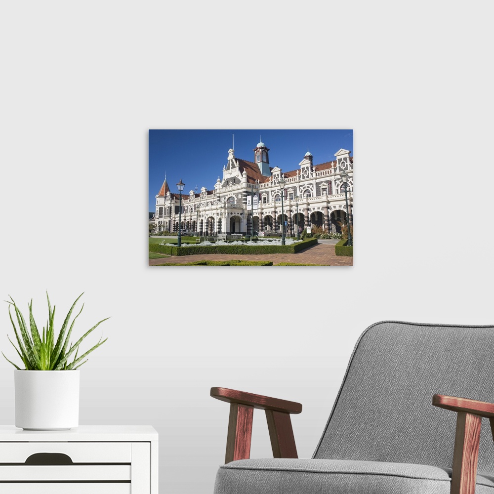 A modern room featuring View from gardens to the imposing facade of Dunedin Railway Station, Anzac Square, Dunedin, Otago...