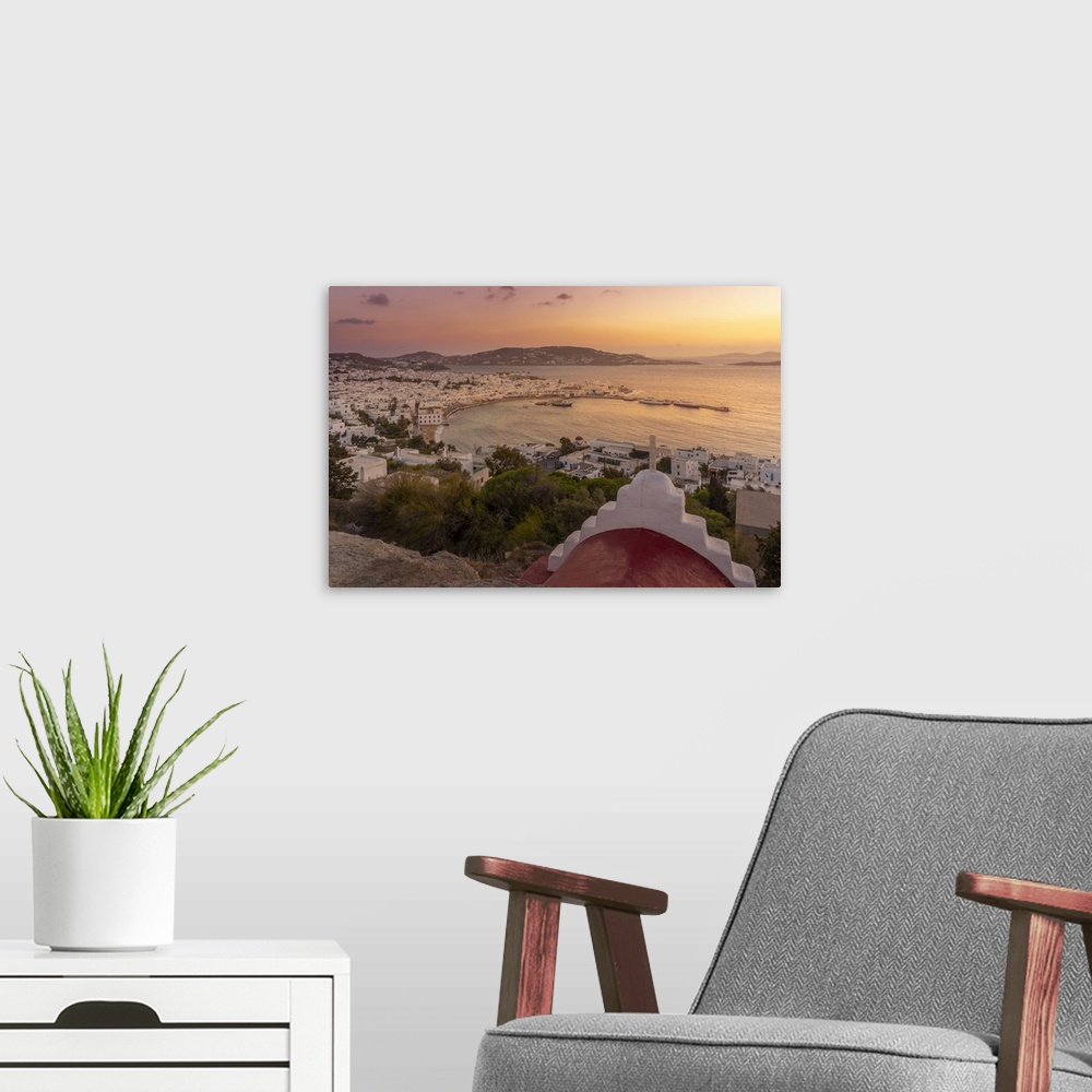 A modern room featuring View of chapel and town from elevated view point at sunset, Mykonos Town, Mykonos, Cyclades Islan...
