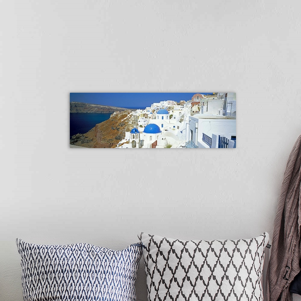 A bohemian room featuring View of Oia with blue domed churches, Santorini, Greek Islands, Greece