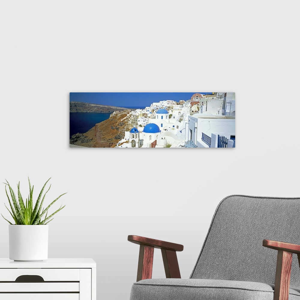 A modern room featuring View of Oia with blue domed churches, Santorini, Greek Islands, Greece