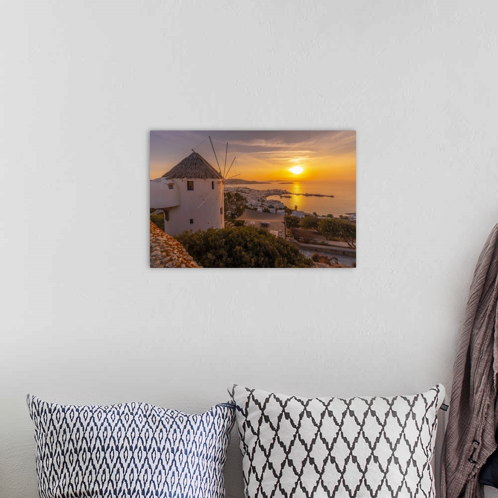 A bohemian room featuring View of windmill overlooking town at golden sunset, Mykonos Town, Mykonos, Cyclades Islands, Gree...