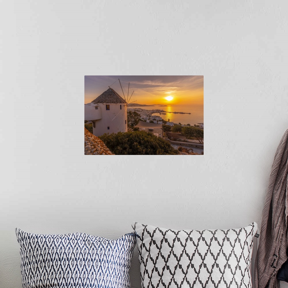 A bohemian room featuring View of windmill overlooking town at golden sunset, Mykonos Town, Mykonos, Cyclades Islands, Gree...