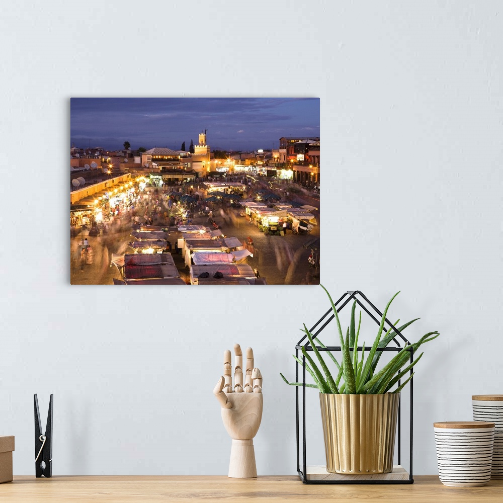 A bohemian room featuring View over Djemaa el Fna at dusk with foodstalls and crowds of people, Marrakech, Morocco, North A...