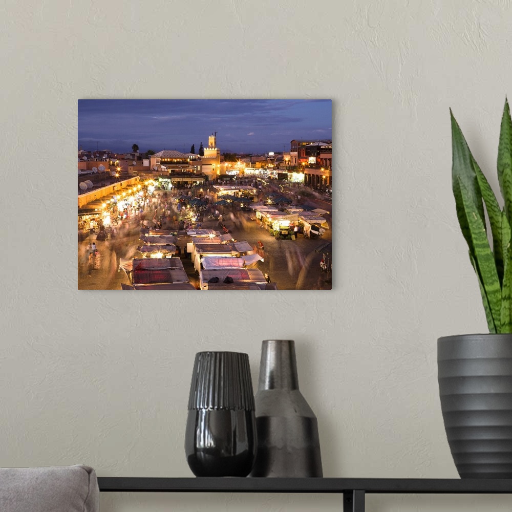 A modern room featuring View over Djemaa el Fna at dusk with foodstalls and crowds of people, Marrakech, Morocco, North A...
