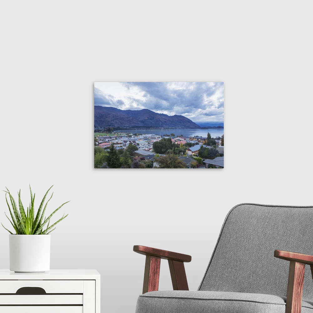 A modern room featuring View over rooftops to Lake Wanaka at dusk, Wanaka, Queenstown-Lakes district, Otago, South Island...