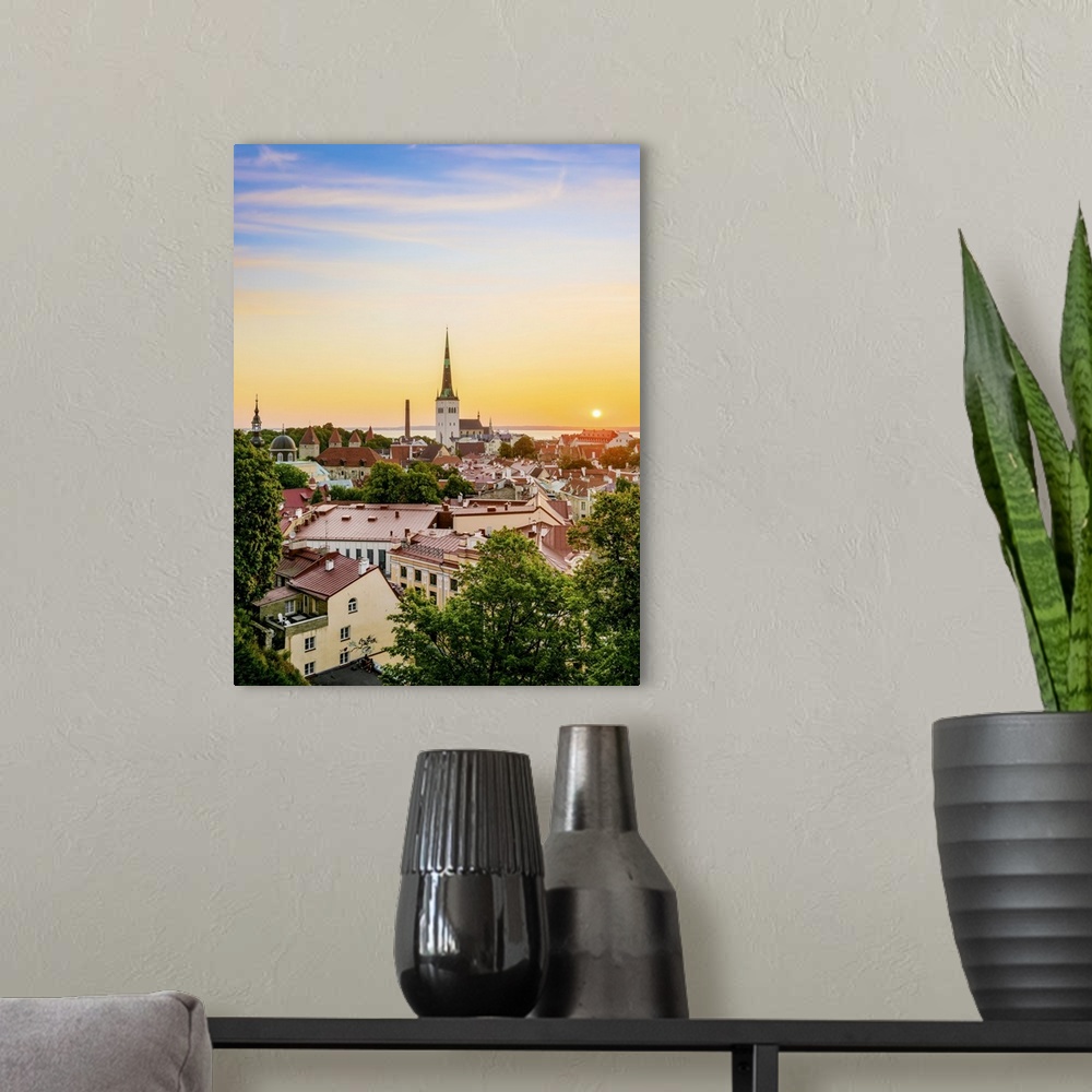 A modern room featuring View over the Old Town towards St. Olaf's Church at sunrise, UNESCO World Heritage Site, Tallinn,...
