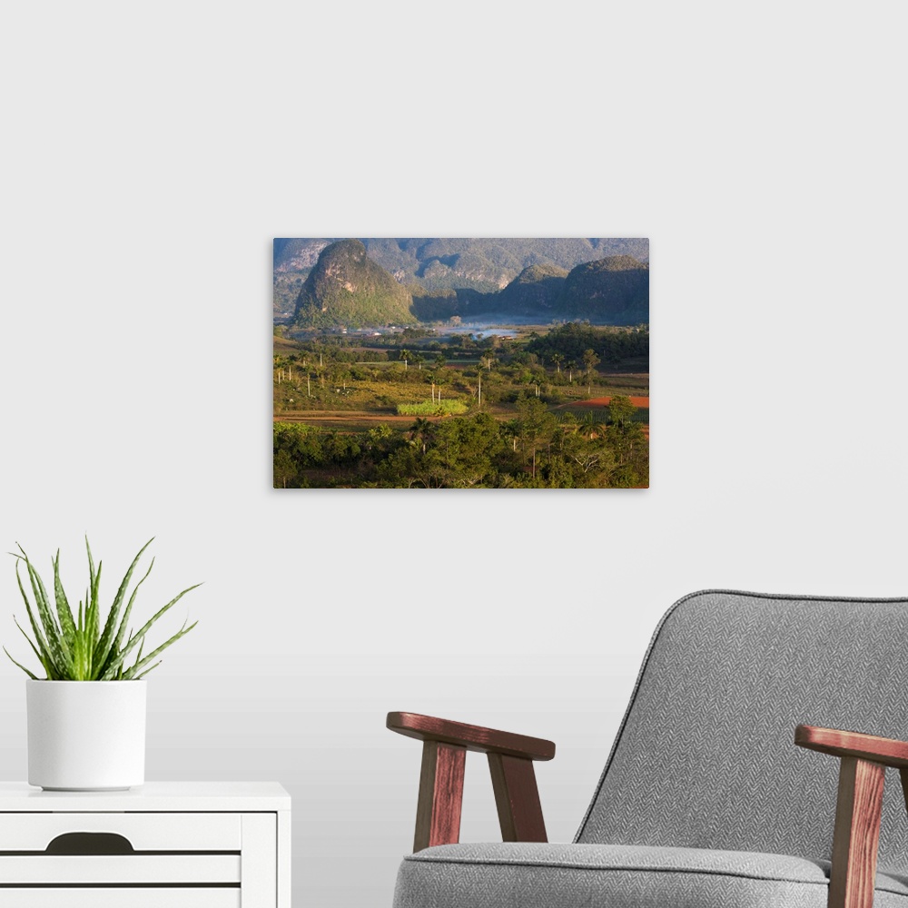 A modern room featuring Vinales Valley, UNESCO World Heritage Site, bathed in early morning sunlight, Vinales, Pinar Del ...