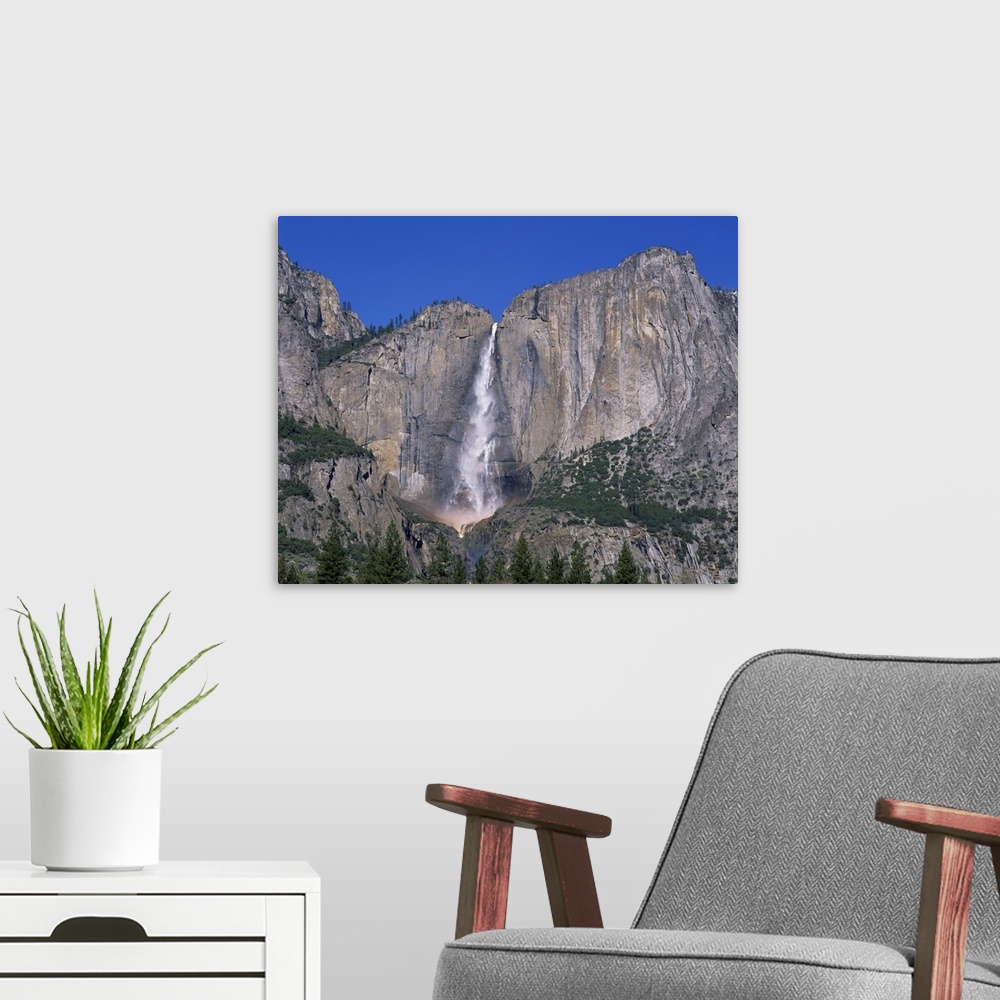 A modern room featuring Waterfall cascades over rock wall at Rainbow Falls in the Yosemite Park, California