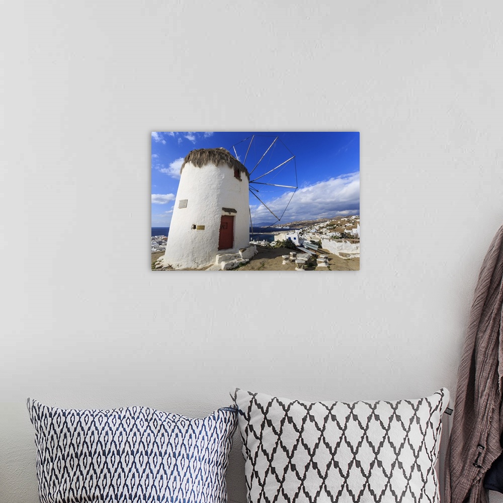 A bohemian room featuring Whitewashed windmill, view of Mykonos Town and cruise ships in distance, Mykonos, Cyclades, Greek...