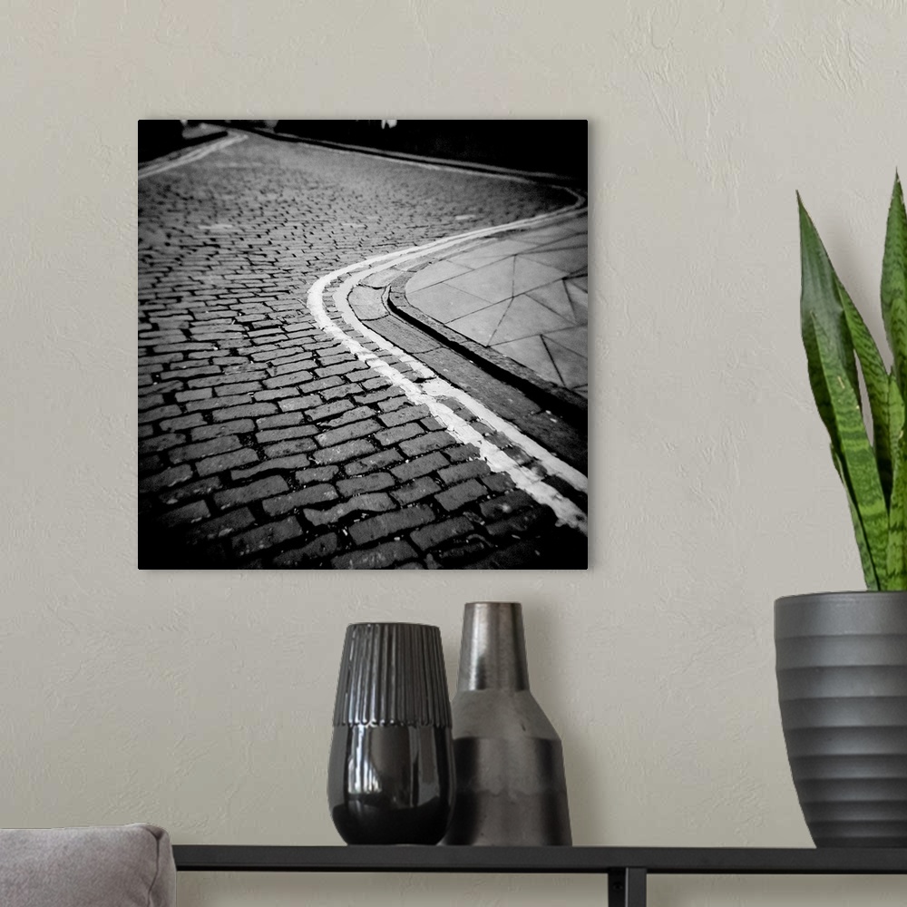 A modern room featuring Winding cobbled street with double yellow No Parking lines, Edinburgh, Scotland, UK