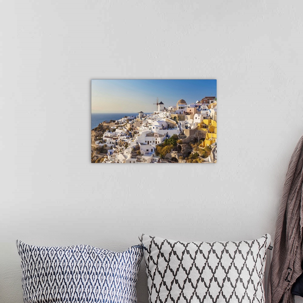 A bohemian room featuring Windmill and traditional houses, Oia, Santorini (Thira), Cyclades Islands, Greek Islands, Greece,...