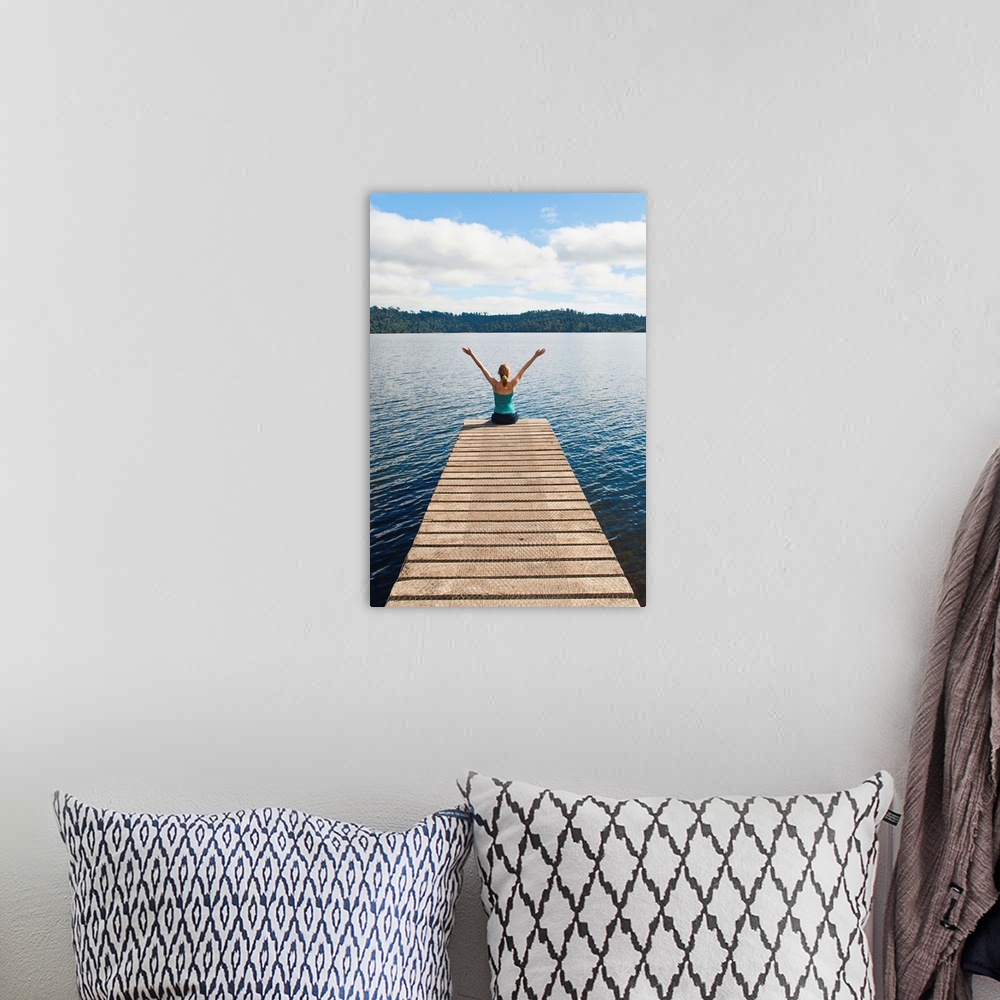 A bohemian room featuring Woman sitting on a jetty, Lake Ianthe, West Coast, South Island, New Zealand, Pacific