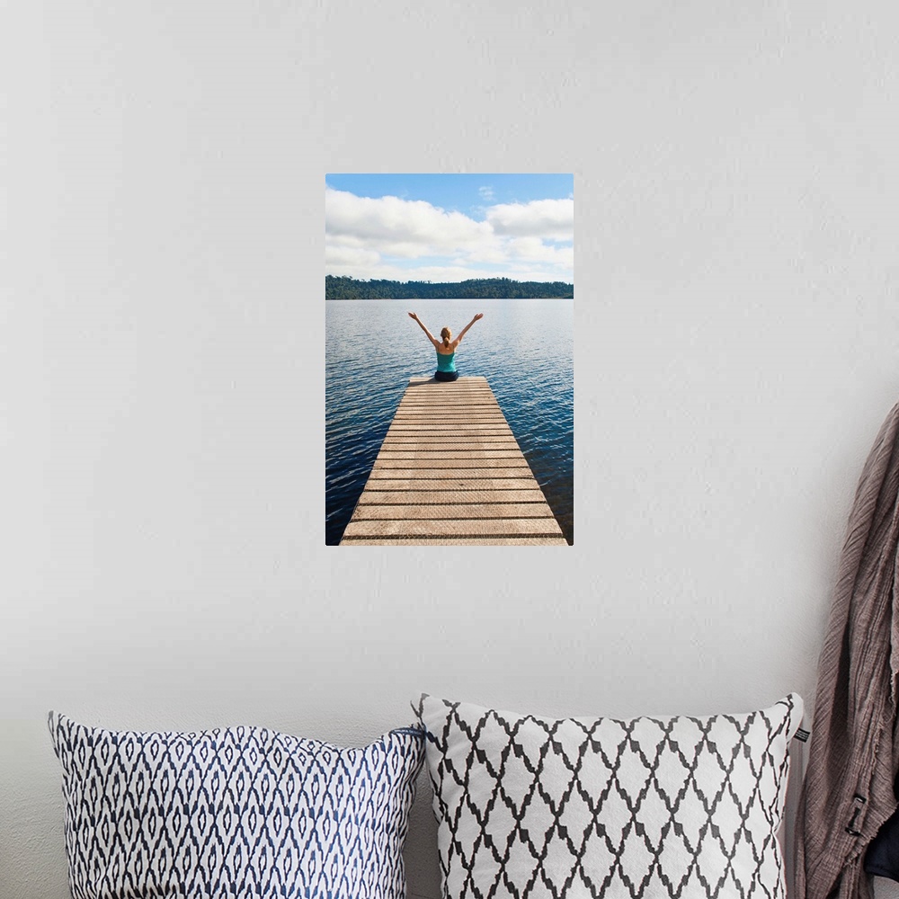 A bohemian room featuring Woman sitting on a jetty, Lake Ianthe, West Coast, South Island, New Zealand, Pacific