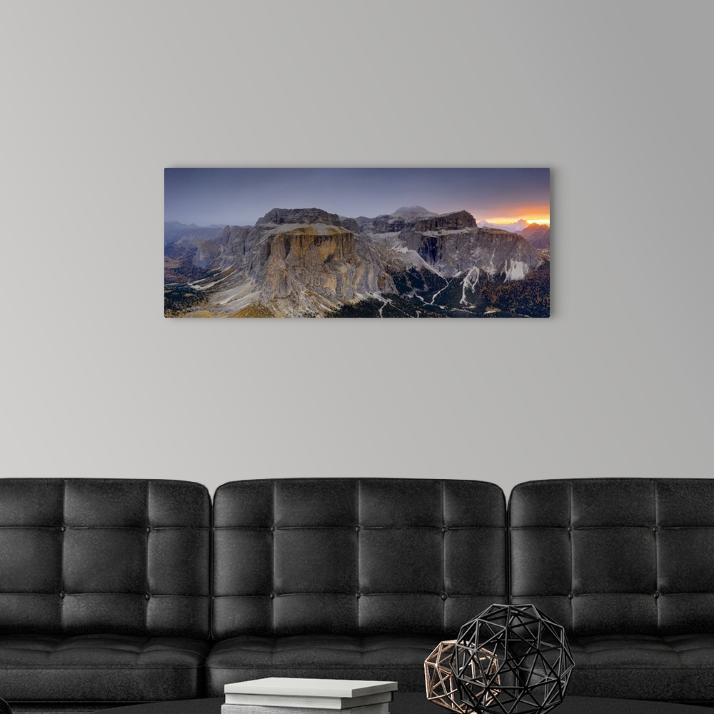 A modern room featuring Woods in autumn at foot of Sass Pordoi and Sella mountain at dawn, aerial view, Passo Sella, Dolo...
