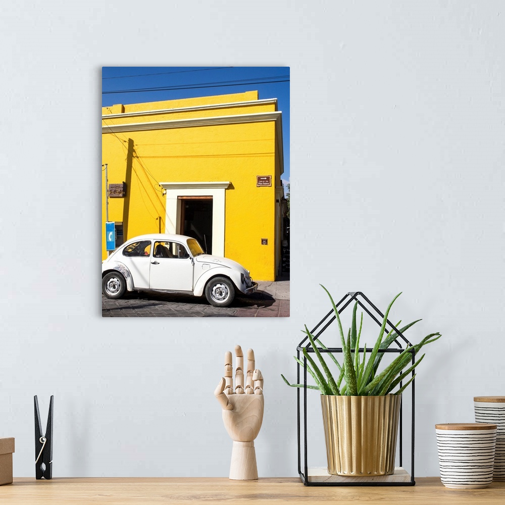 A bohemian room featuring Yellow building and white VW bug, Oaxaca, Mexico, North America