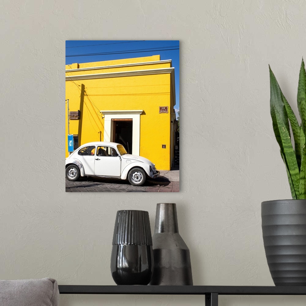 A modern room featuring Yellow building and white VW bug, Oaxaca, Mexico, North America