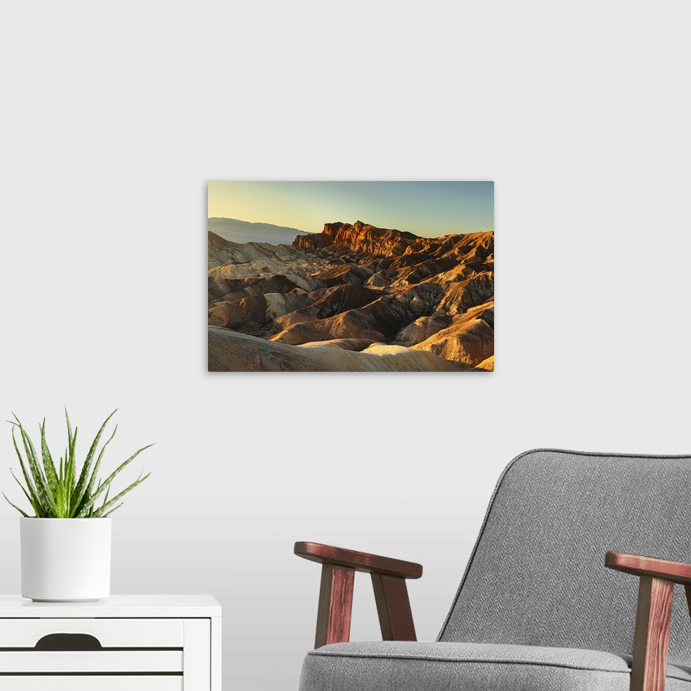 A modern room featuring Zabriskie Point at sunrise, Death Valley National Park, California, United States of America, Nor...