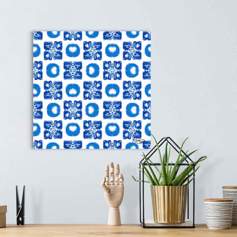 A bohemian room featuring Square artwork with a repetitive pattern of brush stroked circles in blue and white.