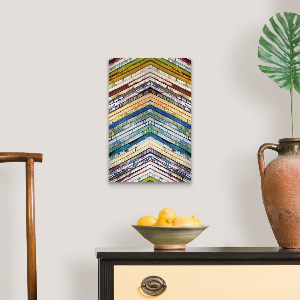 A traditional room featuring Contemporary abstract painting of slatted colorful bars in a chevron pattern pointing up.