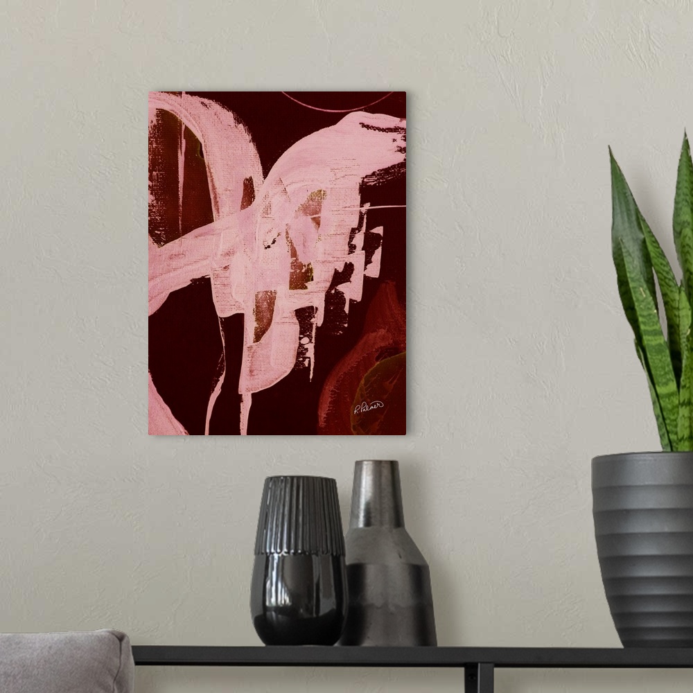 A modern room featuring Abstract painting with a bold burnt red background and brighter pink brushstrokes on top.