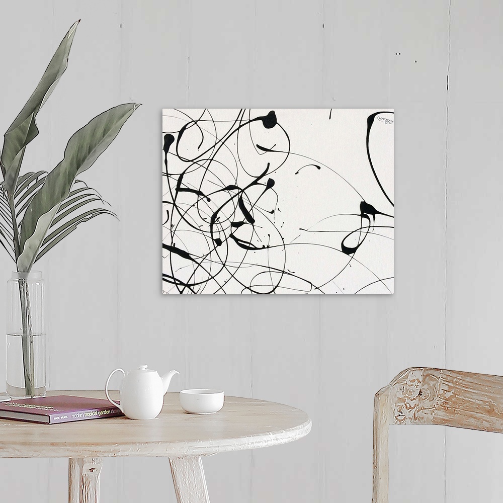 A farmhouse room featuring A contemporary abstract painting of black paint drizzle on a tan background.