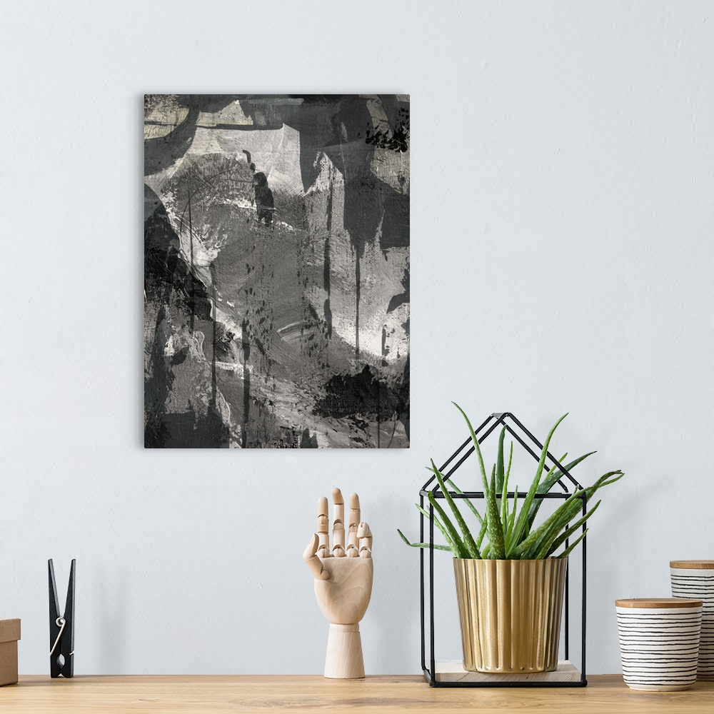A bohemian room featuring Black, white, and gray abstract painting.