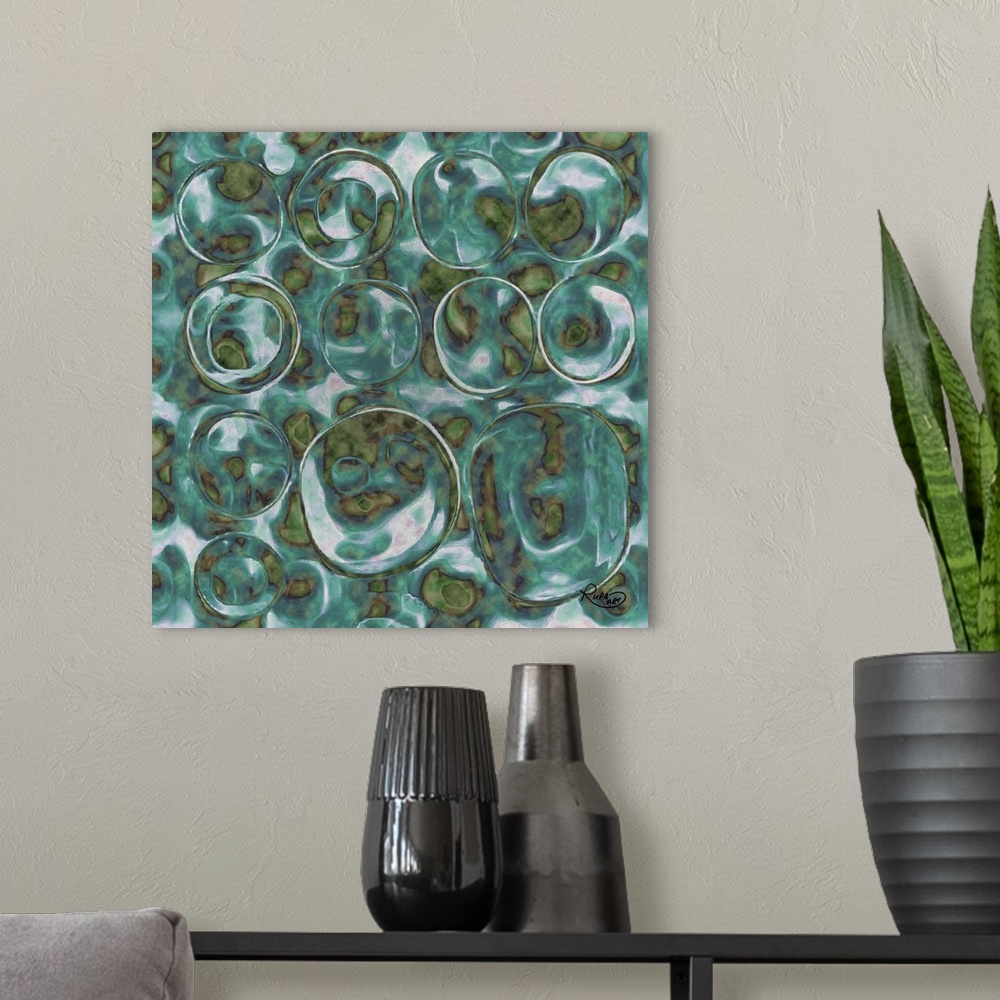 A modern room featuring Square abstract art with translucent bubble like circles made out of green and blue hues.
