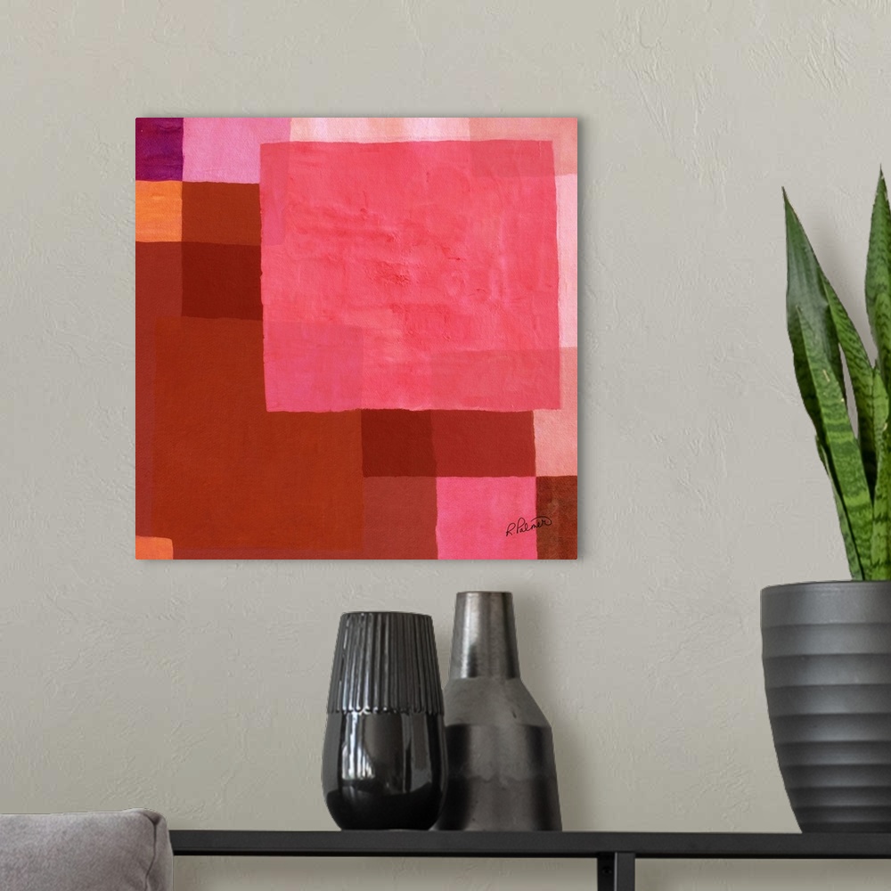 A modern room featuring Square abstract painting with layered geometric squares in shades of pink and red.