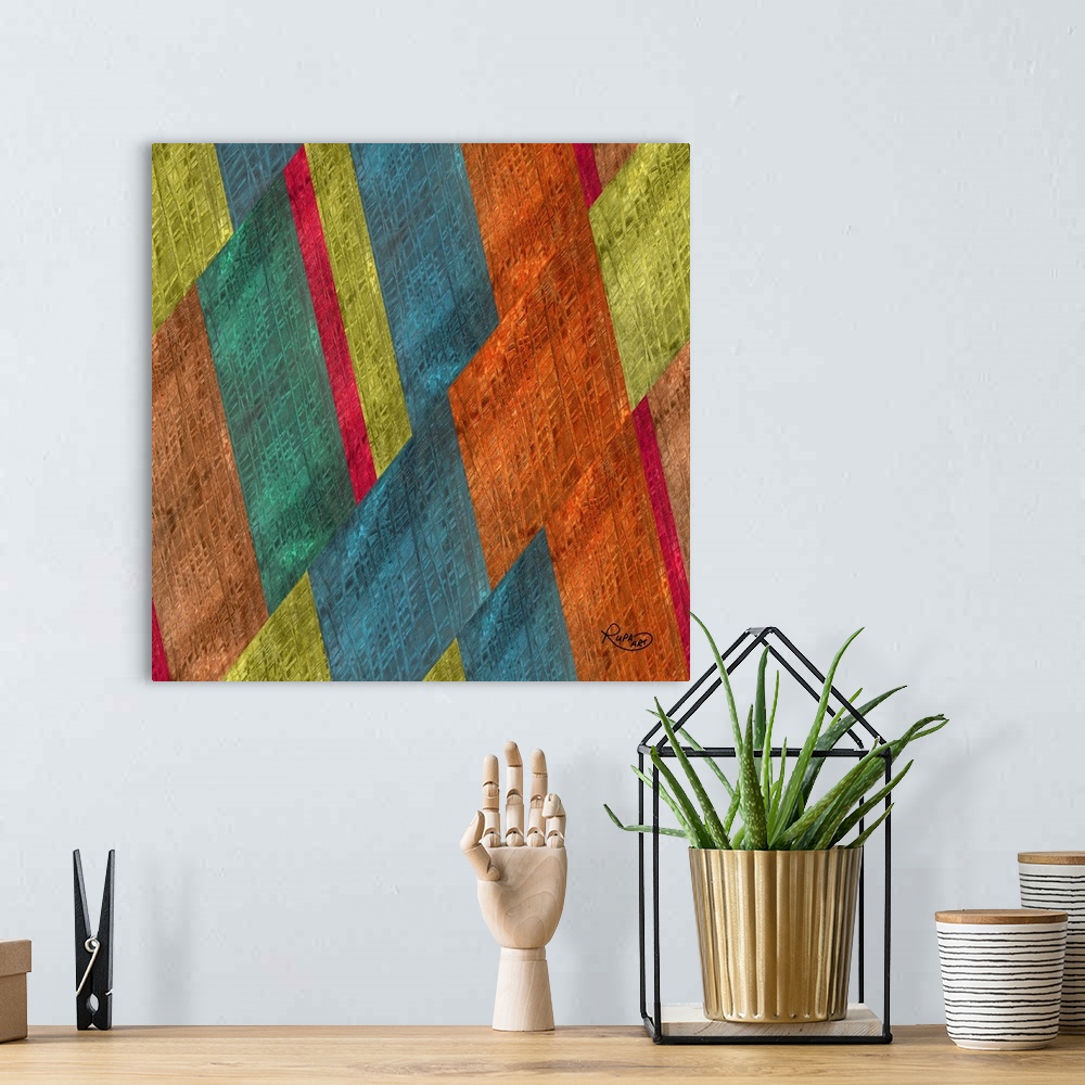 A bohemian room featuring Square abstract artwork in shades of orange, blue and green in a diagonal striped design.