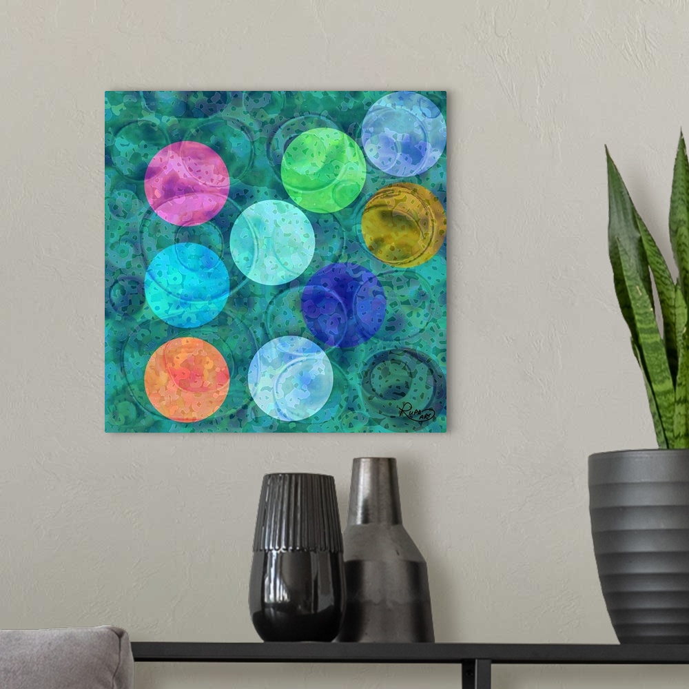 A modern room featuring Square abstract art with colorful circular shapes on top of a blue and green background.