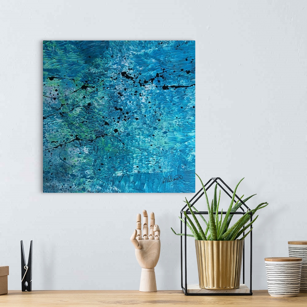 A bohemian room featuring Square abstract painting with a blue, white, and green textured background with black paint splat...
