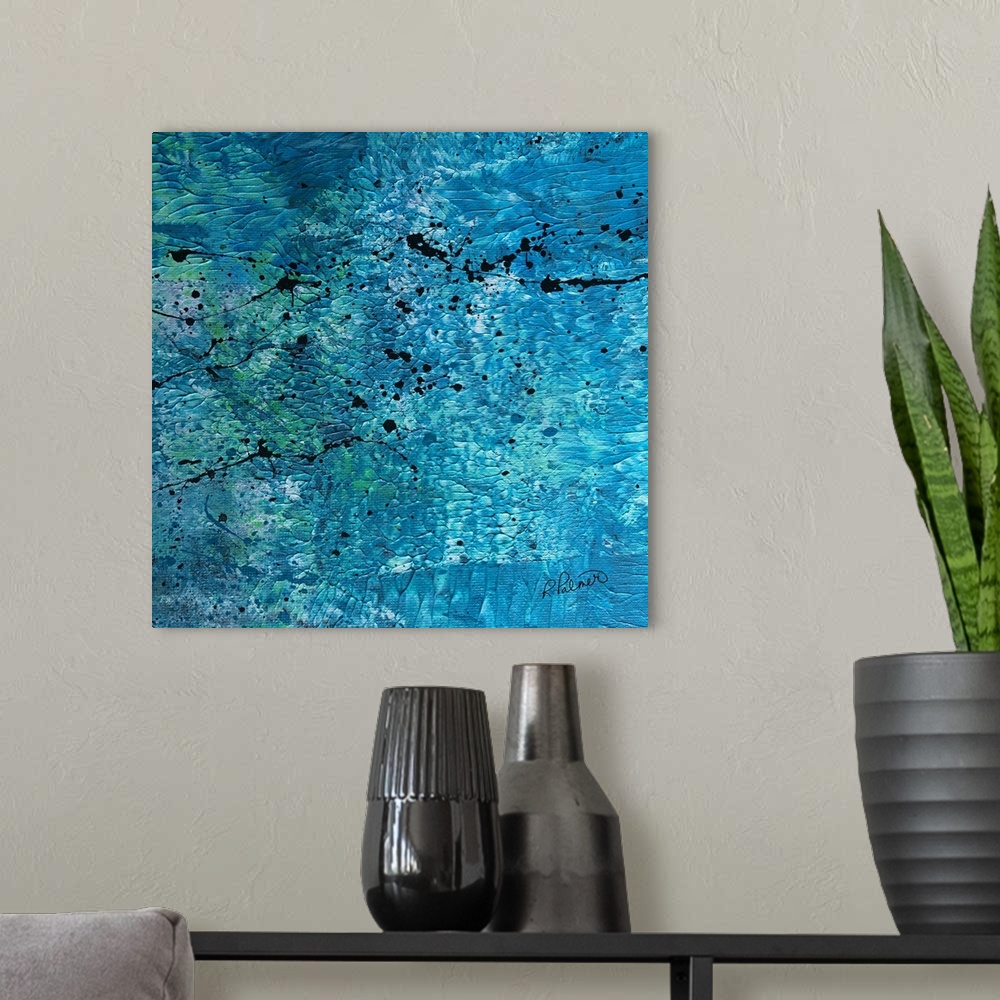 A modern room featuring Square abstract painting with a blue, white, and green textured background with black paint splat...