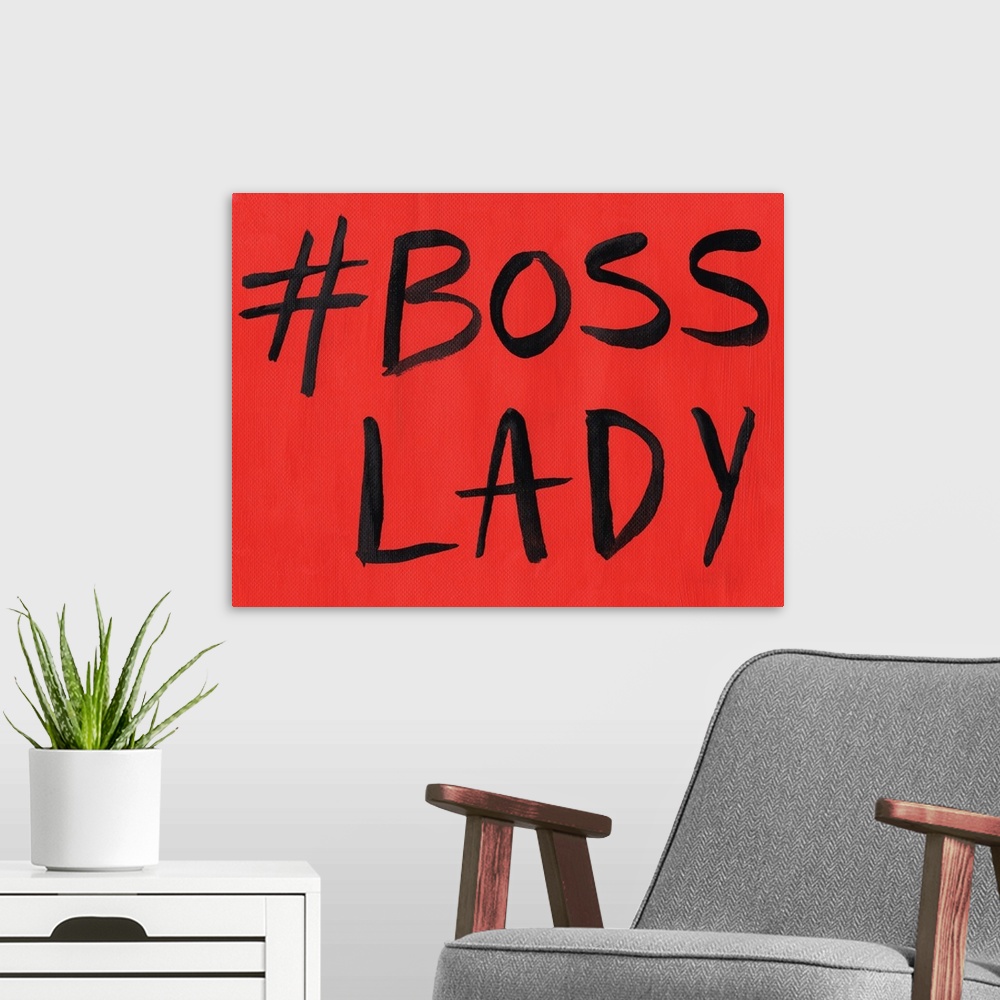 A modern room featuring This artwork features the hashtag, "Boss Lady" in black text over a red background.