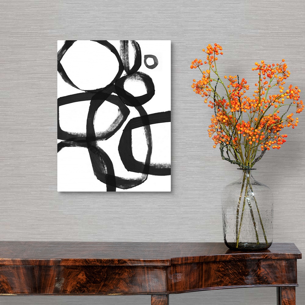 A traditional room featuring Abstract artwork of overlapping black rings made of broad brushstrokes on white.