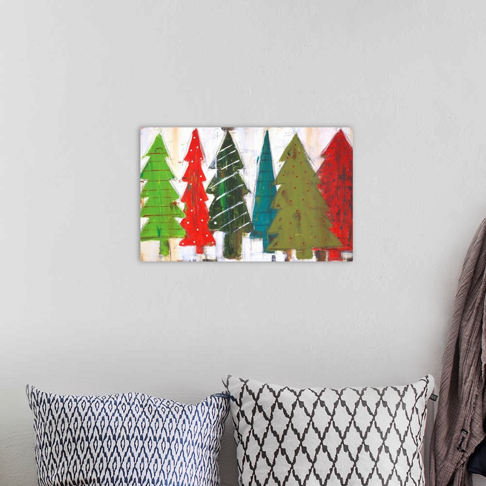 A bohemian room featuring Contemporary painting of different colored and patterned Christmas trees, against a gray background.