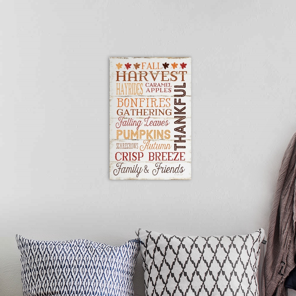A bohemian room featuring Thanksgiving themed typography artwork in festive fall colors against a rustic wooden background.